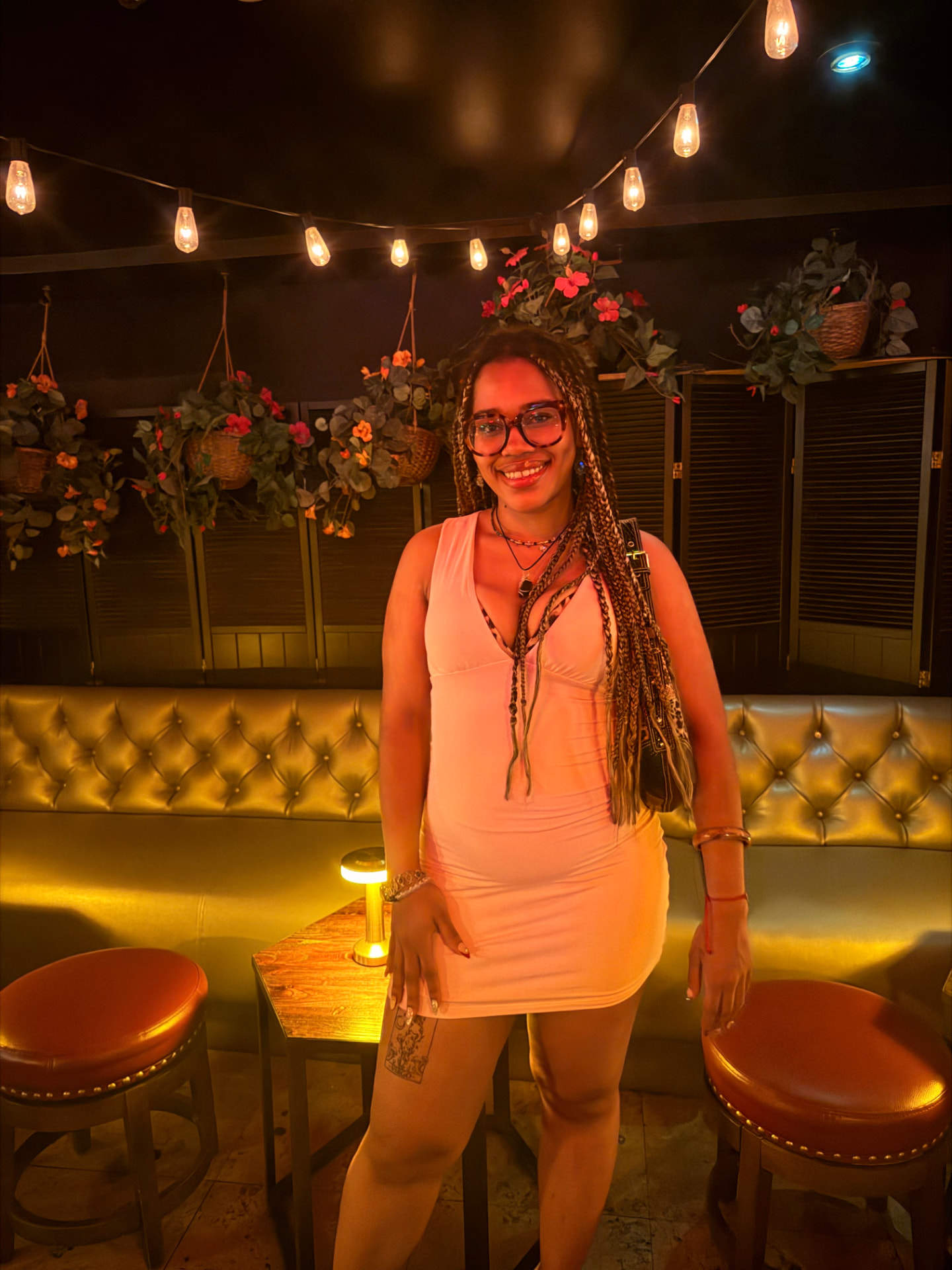 Jayda, founder of Rich Girl Frequency, smiling in warm golden light